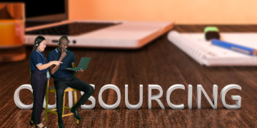 two people in front of the word 'outsourcing'